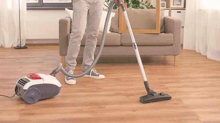 A close-up photo of a steam cleaner releasing steam to sanitize indoor surfaces, emphasizing its natural and chemical-free cleaning method.