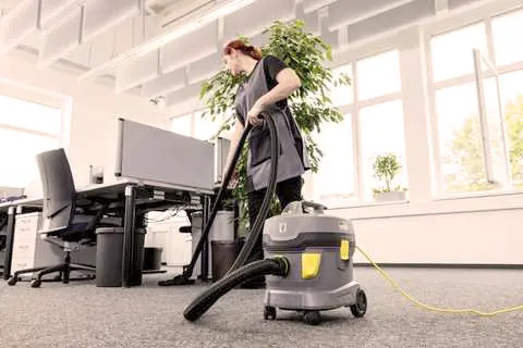 A close-up photo of a steam cleaner releasing steam to sanitize indoor surfaces, emphasizing its natural and chemical-free cleaning method.