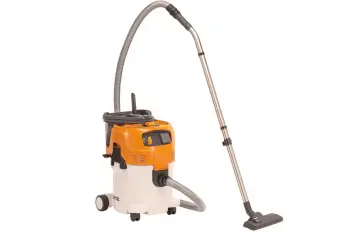 A close-up photo of a steam cleaner releasing steam to sanitize and refresh indoor surfaces without harsh chemicals.