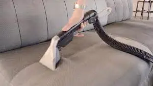 A close-up photo of a steam cleaner releasing steam to sanitize indoor surfaces, highlighting its natural and chemical-free cleaning method.