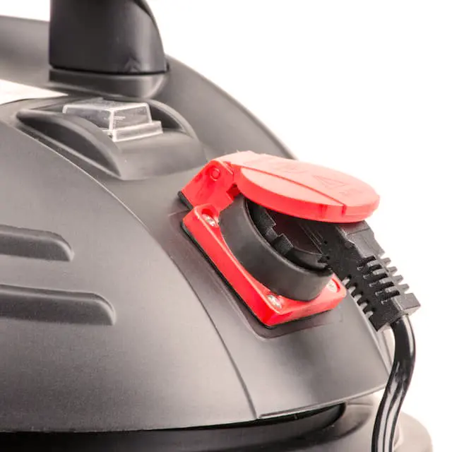 A close-up photo of a steam cleaner releasing steam to sanitize indoor surfaces, emphasizing its natural and chemical-free cleaning method.