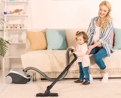 A close-up photo of a steam cleaner releasing steam to sanitize indoor surfaces, emphasizing its natural and chemical-free cleaning method.